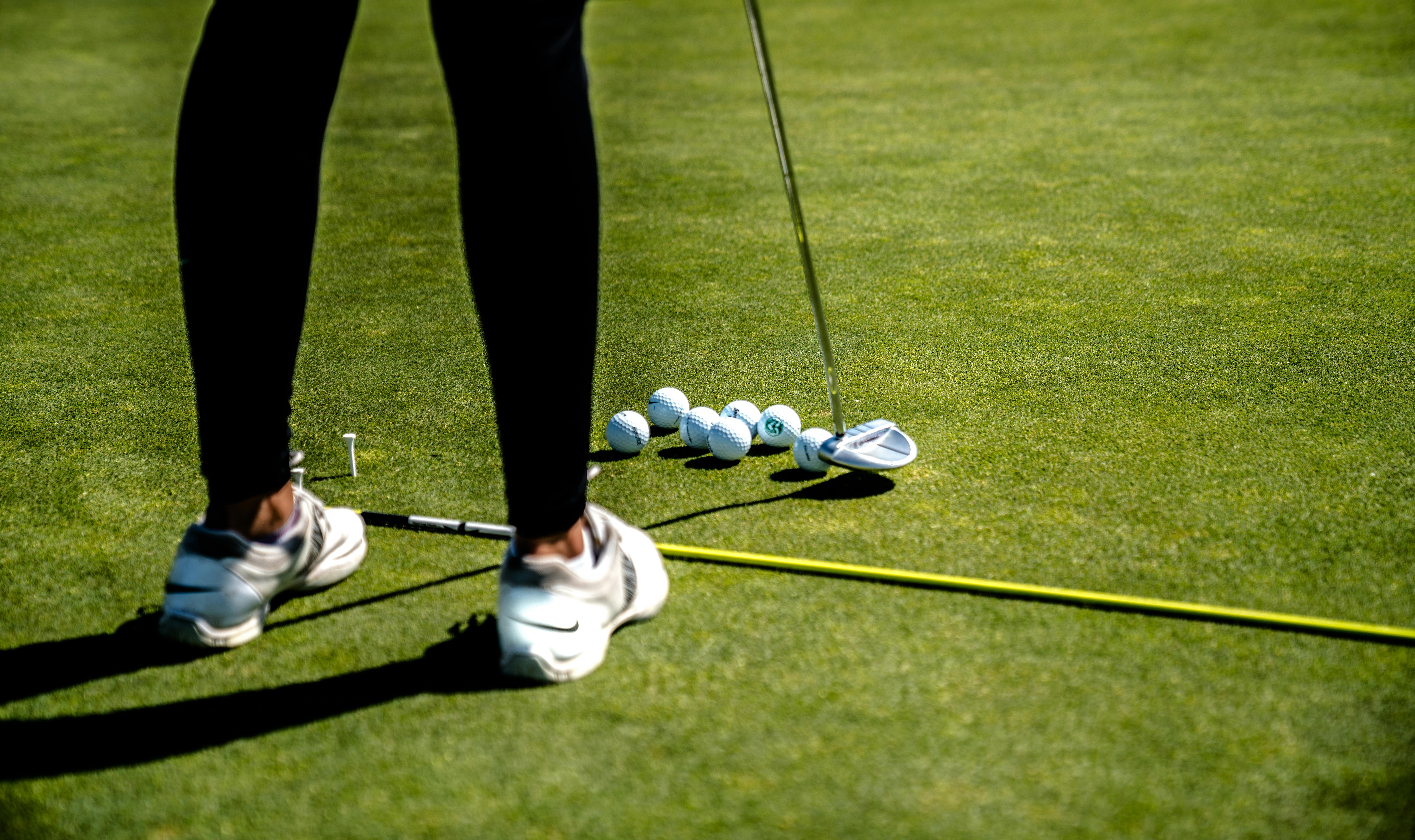 Golfer putting with training aid